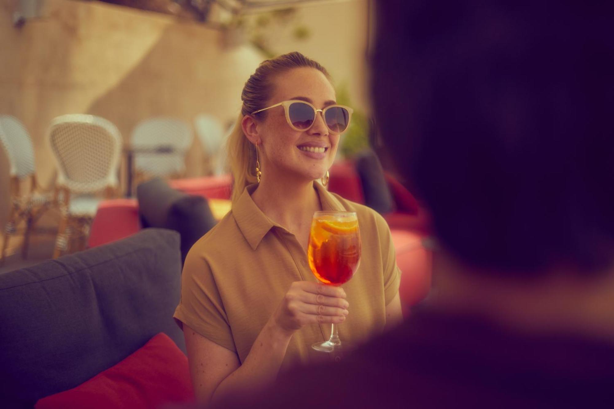 Secrets Mallorca Villamil Resort & Spa - Adults Only Peguera Luaran gambar A woman drinking an Aperol Spritz